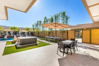 a patio with a table and chairs and a hot tub at Villa with jacuzzi in Marrakech