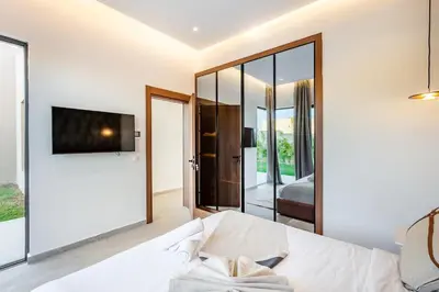 a living room with a bed and a tv at Villa with jacuzzi in Marrakech