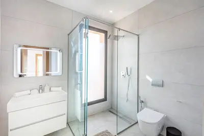 a bathroom with a toilet and a sink and a shower at Modern design and jacuzzi in Marrakech