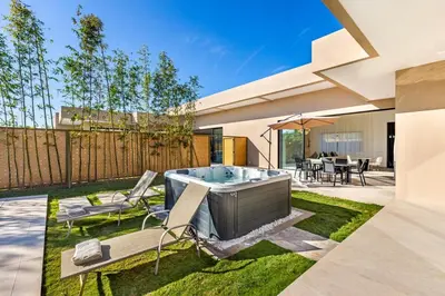 a backyard with a hot tub in a yard at Modern design and jacuzzi in Marrakech