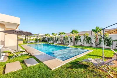 a swimming pool in the yard of a house at Modern design and jacuzzi in Marrakech