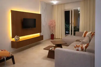 a living room with a couch and a tv on a wall at Central location in Gueliz in Marrakech