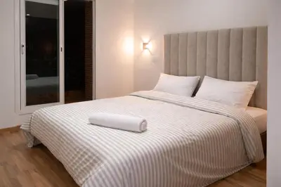 a large white bed with a pillow on top of it at Central location in Gueliz in Marrakech