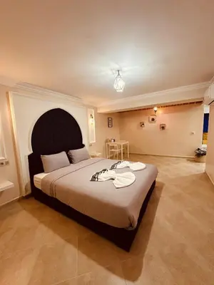 a bedroom with a large bed with a large headboard at Blue and sun Majorelle comfort and spacious in Marrakech