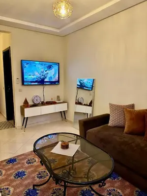 a living room with a couch and a glass table at Gouarial in Marrakech