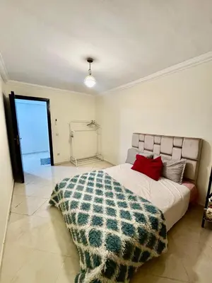 a bedroom with a bed with a blanket on it at Gouarial in Marrakech