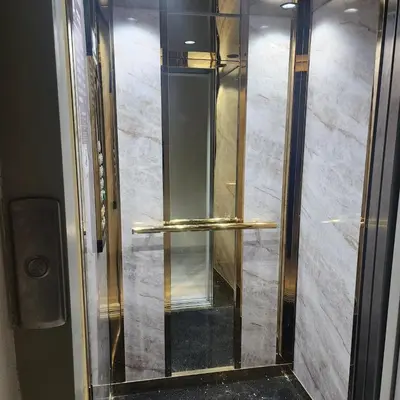 a elevator with a glass door with gold rails at New comfy appartement-centre -Menara-Gueliz-aero in Marrakech