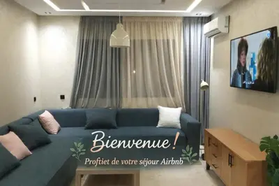 a living room with a blue couch in front of a window at New comfy appartement-centre -Menara-Gueliz-aero in Marrakech