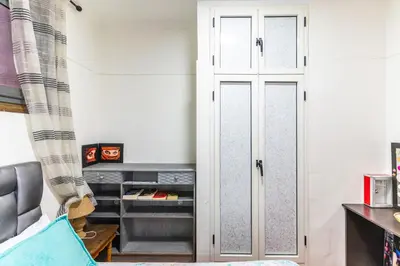 a closet in a room with a bed and a curtain at Heart of Gueliz - Nice 2BR Flat near Train Station in Marrakech