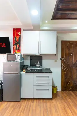 a kitchen with white cabinets and a stove at Heart of Gueliz - Nice 2BR Flat near Train Station in Marrakech