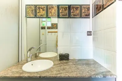 a bathroom with two sinks and a mirror at Heart of Gueliz - Nice 2BR Flat near Train Station in Marrakech