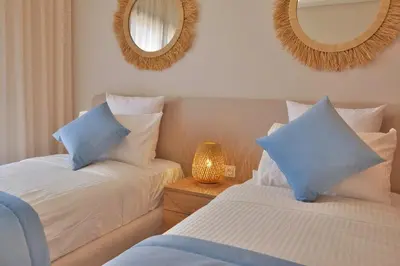 a bedroom with two beds and two mirrors at Marrakech Luxury 2BR Pool View and Terrace for Remote Work in Marrakech