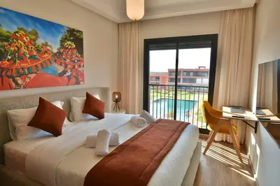 a bedroom with a large bed and a large window at Marrakech Luxury 2BR Pool View and Terrace for Remote Work in Marrakech