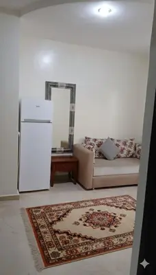 a living room with a couch and a white refrigerator at Au Cœur de L'hivernage P09 in Marrakech