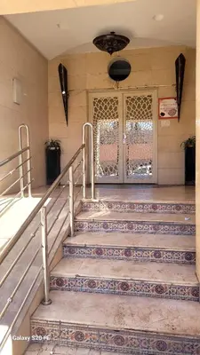 a set of stairs in a building with a door at Au Cœur de L'hivernage P09 in Marrakech