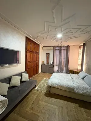 a large bedroom with a bed and a couch at Appartement plein centre marrakech p in Marrakech