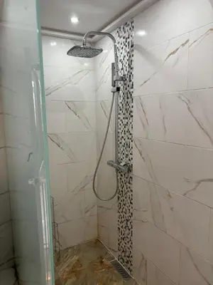 a bathroom with a shower with a glass door at Appartement plein centre marrakech p in Marrakech