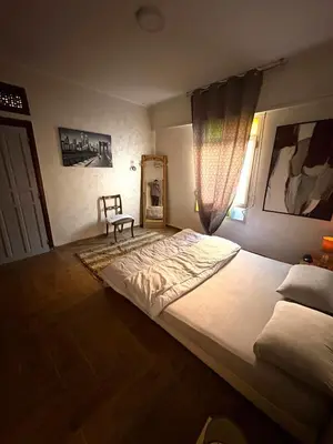 a bedroom with a large bed and a window at Appartement plein centre marrakech p in Marrakech