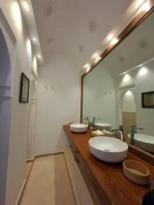 a bathroom with two sinks and a large mirror at Riad Millefeuilles in Marrakech