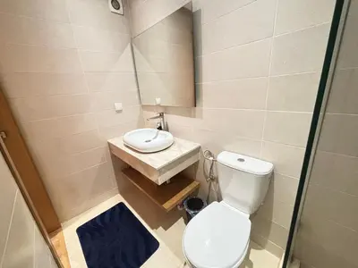 a small bathroom with a toilet and a sink at F2 Cozy and Swimming pool in Marrakech
