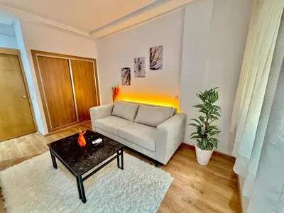 a living room with a couch and a table at F2 Cozy and Swimming pool in Marrakech