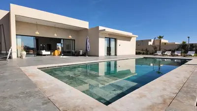 a swimming pool in front of a house at Villa Janna heated pool without overlooking in Marrakech