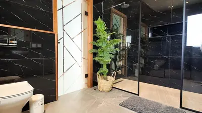 a bathroom with a toilet and a plant at Villa Janna heated pool without overlooking in Marrakech