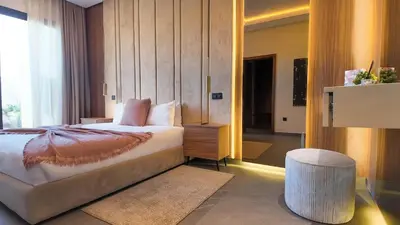 a bedroom with a bed and a large window at Villa Janna heated pool without overlooking in Marrakech