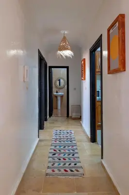 a hallway with a rug on the floor at Dar Joud in Marrakech