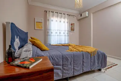 a bedroom with a blue bed and a table at Dar Joud in Marrakech