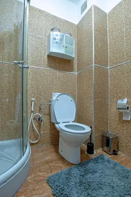 a bathroom with a toilet and a glass shower at Dar Joud in Marrakech