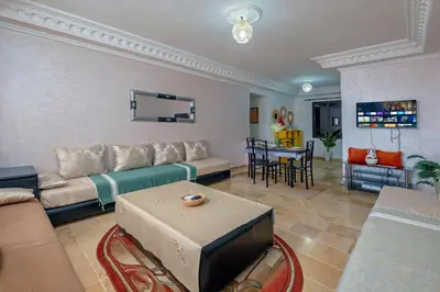 a living room with a couch and a table at Dar Joud in Marrakech
