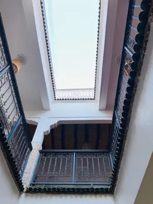 an overhead view of a staircase with a window at l'oasis de Bab Ghmat in Marrakech