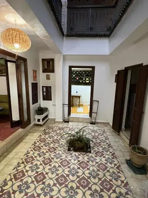 a large room with a large rug on the floor at l'oasis de Bab Ghmat in Marrakech