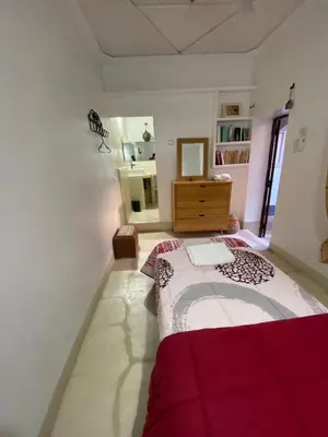 a bedroom with a bed and a dresser and a mirror at l'oasis de Bab Ghmat in Marrakech