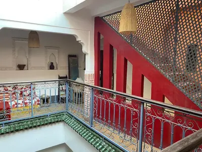 a stairway with a red and white railing at l'oasis de Bab Ghmat in Marrakech