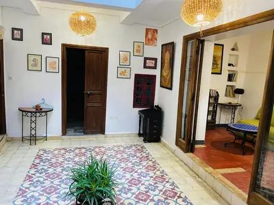 a living room with a door and a rug at l'oasis de Bab Ghmat in Marrakech