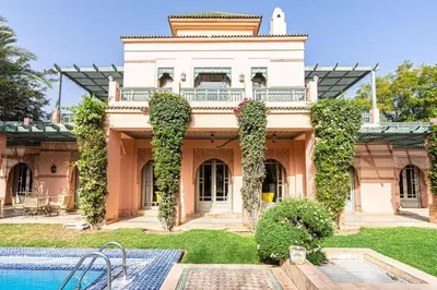 a large house with a swimming pool in front of it at Villa Soleil Private Pool & Garden in Marrakech