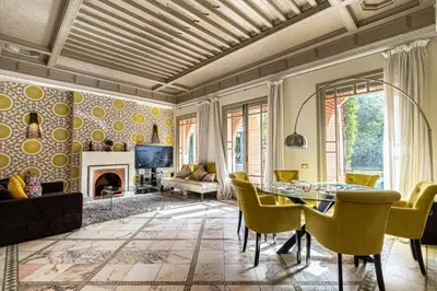 a living room with a dining table and a fireplace at Villa Soleil Private Pool & Garden in Marrakech