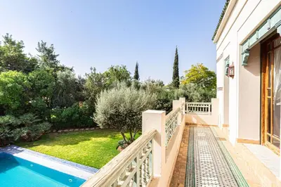 a house with a swimming pool and a balcony at Palmeraie Collection Villa & Piscine in Marrakech