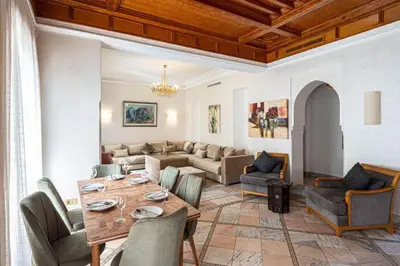 a living room with a table and a couch at Palmeraie Collection Villa & Piscine in Marrakech
