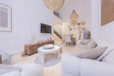 a living room with white furniture and a table at Sublime 3-bedroom duplex with pool in Marrakech