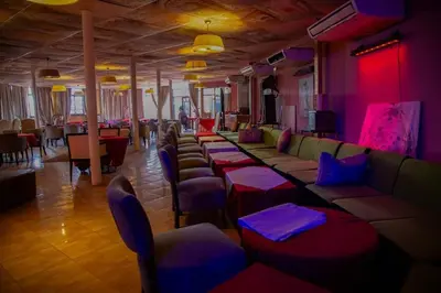 a bar with couches and tables in a room at GRAND HOTEL TAZi in Marrakech