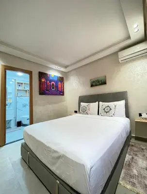 a bedroom with a large white bed in a room at Comfort Suites Marrakech in Marrakech