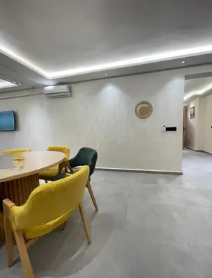 a meeting room with a table and chairs and a wall at Comfort Suites Marrakech in Marrakech