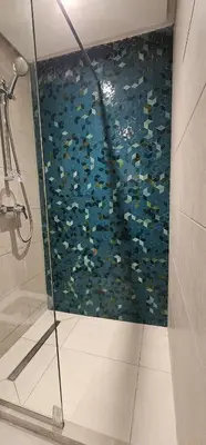 a shower with a glass door in a bathroom at Muma Appartment in Marrakech