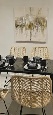 a table with bowls and plates on it with two chairs at Muma Appartment in Marrakech