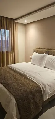 a bedroom with a large white bed with a window at Muma Appartment in Marrakech