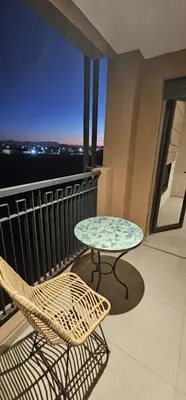 a table and chairs on a balcony with a view at Muma Appartment in Marrakech