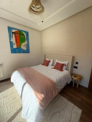a bedroom with a bed and a painting on the wall at Exceptional Villa Private Pool and Breakfast in Marrakech
